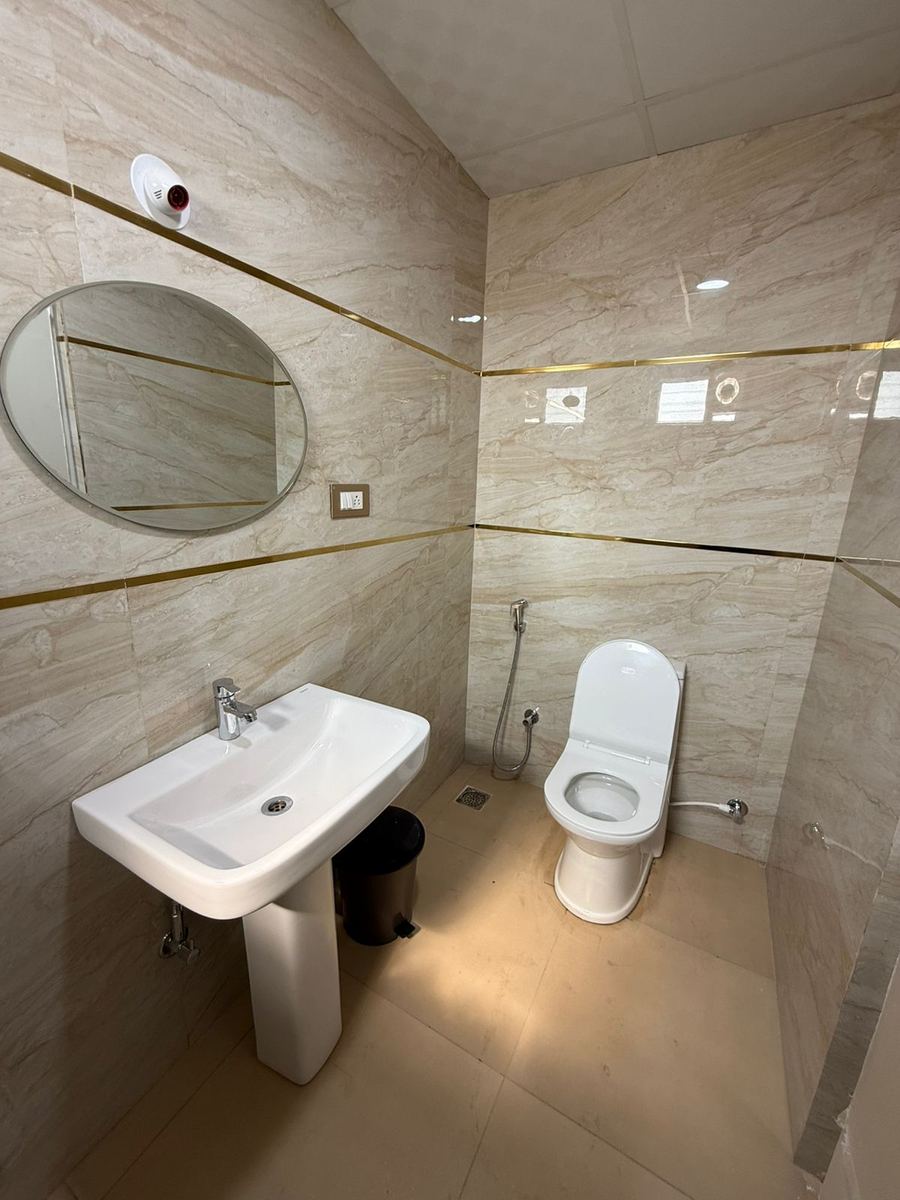 Elegant bathroom with marble walls and gold accents